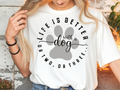 T-Shirt – „Life is better with a dog or two, or three"